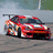 Pixelated red sports car with black accents and white racing stripes on a gray track background.