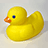 Yellow rubber duck with orange beak and blue eye on light gray background, accompanied by blue pixelated text blocks.