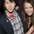 Two people pose closely together on the left side of a split composition, with bright pink background and red text reading "I love him!!!!" on the right.