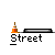 Pixelated skater in green shirt and blue pants performs tricks on a gray background with orange traffic cones, black ramps, and white 'Street' text.