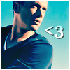 Pixelated image of a person in a dark blue shirt with a white stripe, set against a light blue background, featuring a white '<3' symbol on the right.