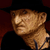 Pixelated static image of a person wearing a black hat and dark clothing against a red background, with visible dithering and low-resolution rendering artifacts.