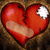 A red heart with a bandage and a white patch on a brown textured background, next to the word 'broken' in white text on black.