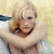 A pixelated contact sheet showing two frames of an animated icon featuring a blonde woman in a swimsuit on the left and green text reading "Original Icons .com" on the right against a dark background.