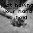 Black-and-white image of two hands clasped together with overlaid pixelated text reading "just having your hand to hold means the world to me <33".