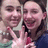 Two pixelated figures in close proximity, one with light hair and the other with dark hair, both smiling broadly.