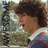 Pixelated image of a person with curly brown hair wearing a white-collared shirt, with text reading 'yeah.' on a black background.