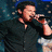 A four- shows a person in various poses: singing into a microphone, neutral expression, smiling with hand behind head, and blank space