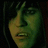 Pixelated image of a person with dark hair and greenish skin tone, accompanied by red pixelated text on black background.