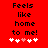 Red background with black text reading 'Feels like home to me!' and five white hearts, one pink heart in the center.