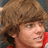 A pixelated image of a person with brown hair wearing red clothing, with cyan text reading ALELUIA overlaid on the right side.