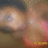 Pixelated close-up of a figure with light skin tones, dark hair, and a pink and orange garment against a muted brown background.