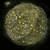 Circular icon with textured beige and yellow pattern, small light square in top-left corner, black background, and a white rectangular overlay on the right side.