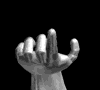 A grayscale animated sequence showing a hand's index finger extending from a curled fist