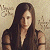A 50x50 pixel animated buddy icon featuring a woman with long dark hair on the left and green text "Original Icons .com" on a dark green background on the right, displayed as a contact sheet of two frames.