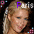 A static image of a woman with blonde hair styled in braids, wearing a white headband and smiling slightly against a black background.
