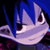 Pixelated static image of a character with blue hair and purple skin features against dark background, likely from Disgaea franchise.