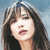 Static pixelated image of a woman's face with long dark hair and bangs against a light blue background, rendered in low-resolution style typical of early 2000s buddy icons.