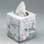 A pixelated cube-shaped object with floral patterns and a white top, displaying text that changes from no visible text to "God bless you." on the right side.