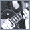 Black-and-white pixelated images of a person with long hair playing electric guitar, seated in profile view, and close-up face showing serious expression.