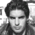 Black-and-white pixelated portrait of a person with dark hair against light background, adjacent to green text reading 'Original Icons .com' in bright green.