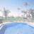 Pixelated beach scene with palm trees and pool on left, green text 'Heyy Beach Bumm' top right, 'Summer 08 is gonna COME' bottom left on blue background.