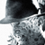 Static grayscale icon depicting a partial figure with dark and light pixelated areas suggesting motion blur or abstract form against white background.