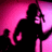 Silhouette of a figure with long hair holding an object against a pink gradient background, rendered in low-resolution pixel art style.