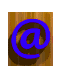 Blue @ symbol on wooden background with shadow, transitioning to 'EMAIL ME' text in blue on same background, then rotating to show side view of text, returning to @ symbol.