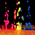 Animated scene with colorful falling shapes on a dark background transitioning to static images of abstract forms, heart symbol, Ferris wheel, and text.