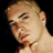 Static 48x48 pixel icon showing a close-up of a person's face with light skin tone, short hair, and visible facial features against black background.