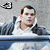 Pixelated image of a person in a white shirt and dark jacket leaning over a blue railing with text fragments below.