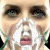 A pixelated image of a person with an oxygen mask, surrounded by repeated text fragments on a black background.