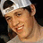 Pixelated image of a person wearing a white cap and gray shirt with text 'Malk And Cookies! <3' on black background.