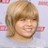 Static 48x48 pixel icon showing a close-up of a person's face with light brown hair and a smiling expression, rendered in low-resolution pixel art style on a pale blue background.
