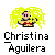 Pixelated icon of a person with bright yellow hair, pink eyewear, and red chest marking against gray background.