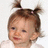 Pixelated close-up of a child's face with brown hair styled in two small buns, light skin tone, and closed eyes against a white background.