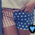 Pixelated image of a person wearing blue polka-dot shorts with white dots, light-colored checkered fabric in background, and two blue heart icons.