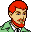 Pixelated cartoon character with red hair, green jacket, and checkered shirt against gray background.