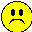 Four yellow pixelated smiley faces arranged in a , each with distinct black facial features on gray background