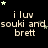 Black background with repeated text 'i luv souki and brett' in light brown pixelated font, surrounded by small green and gray stars.