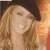 Three distinct views of a woman with long blonde hair smiling, wearing different outfits and headwear against varied backgrounds.