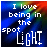 Static pixel art icon with rainbow gradient background and white text reading "I love being in the spotlight" arranged vertically, featuring a blue-to-red color transition from bottom to top.