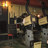 A pixelated static image shows a dimly lit interior with warm yellow and orange lighting, featuring indistinct shapes and a blurred background.