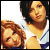 Two women in white shirts with blue trim pose closely together as text above them changes from 'B' to 'BEST FRIENDS'.