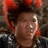 A person with voluminous dark hair styled upward, wearing a red headband and black leather jacket, shown in three with subtle facial expression changes