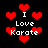 Pixelated red hearts and white text reading "I Love Karate" on a black background, with varying heart sizes and positions.