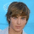 Pixelated image of a person with brown hair against a light blue background, paired with cyan text on black and gray