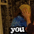 Two people embrace in a dimly lit room with patterned wallpaper; text overlays read "you are terrible friend" across four