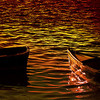 A static icon depicts a sailboat on water with a dark silhouette on the left, rendered in warm orange and yellow tones.